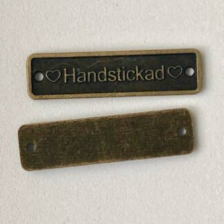 Platta "Handstickad" antik mässing